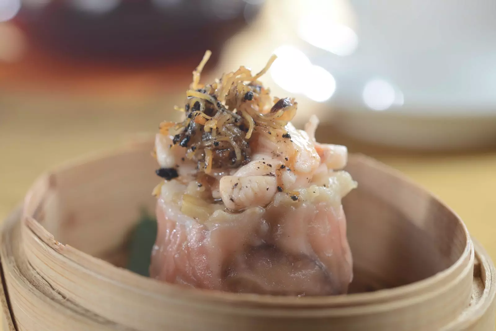 Steamed Lobster and Pork Dumpling with Black Truffle XO Sauce at Kwan Cheuk Heen Restaurant.