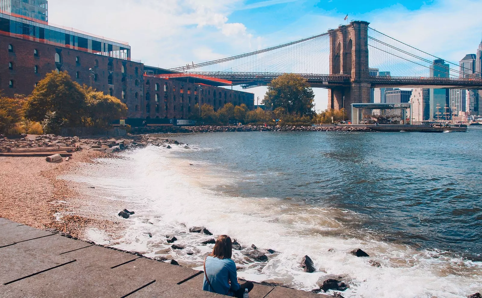 A girl looks at the Brooklyn Bridge