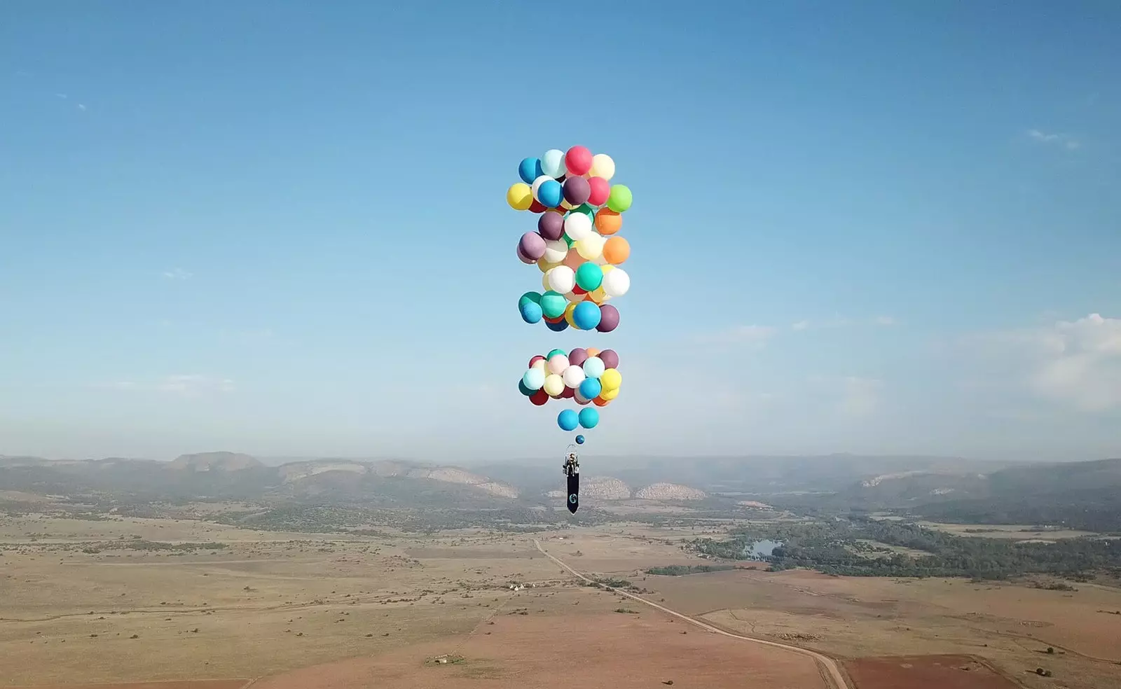 Party balloons and a camping chair the best adventure machine for the British Tom Morgan