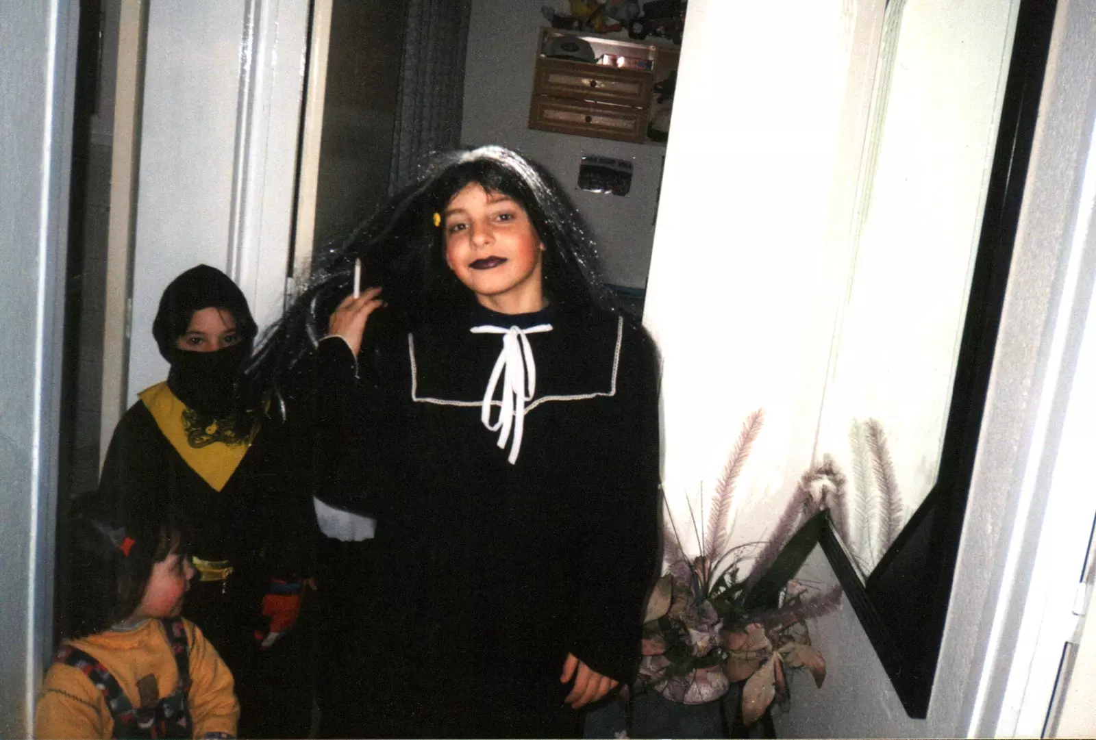 Photograph of Xavi Reyes as a child with a black dress and a wig