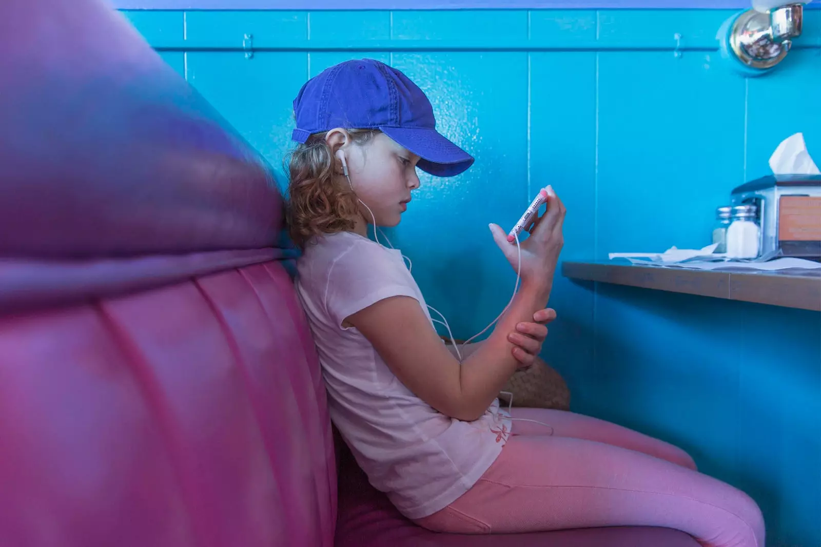 girl looking at mobile in restaurant