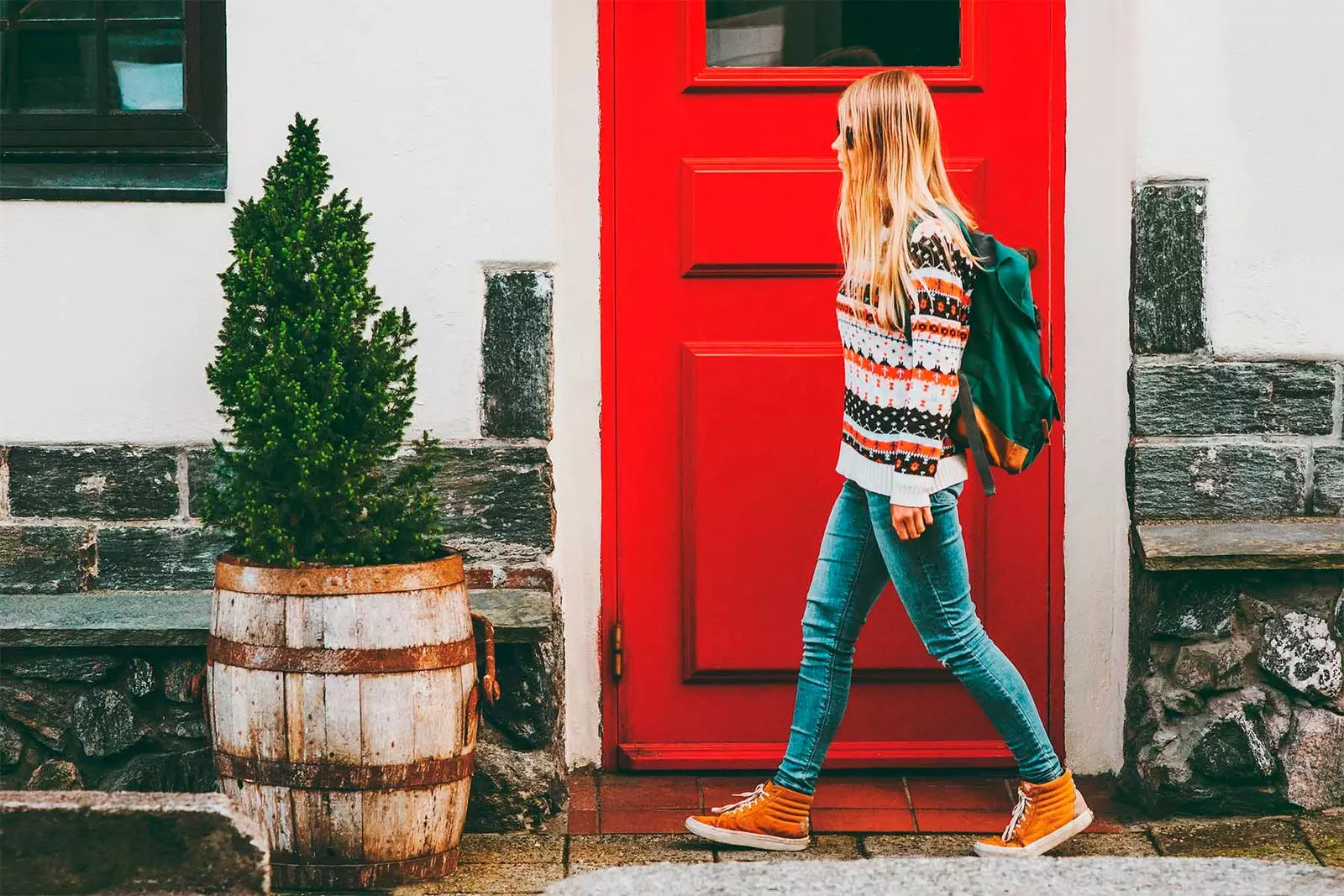 girl walking red door