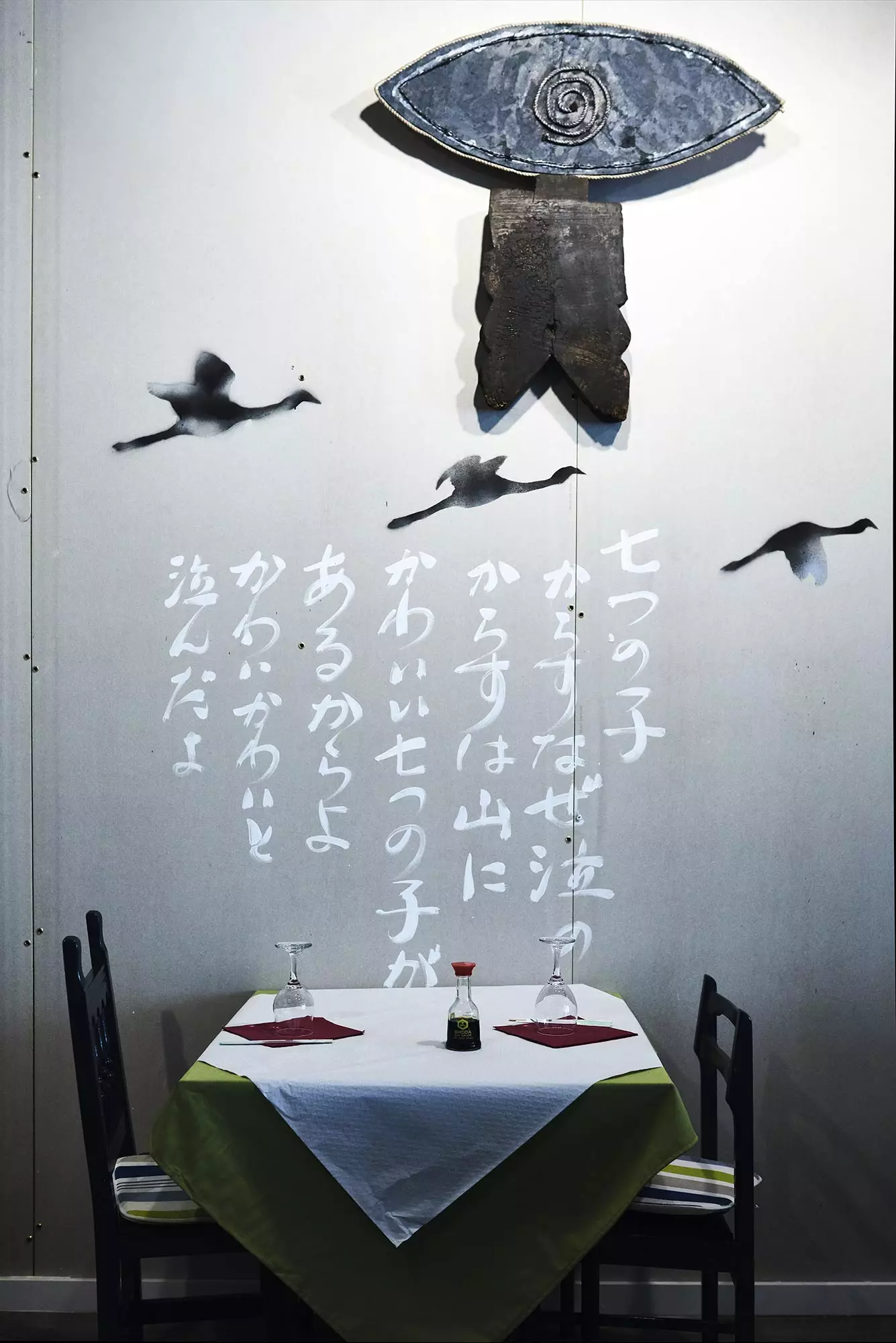 A table at the Yamaoka Tavern. On the wall you can read the lyrics of the Japanese children's song 'Nanatsu no ko' by...