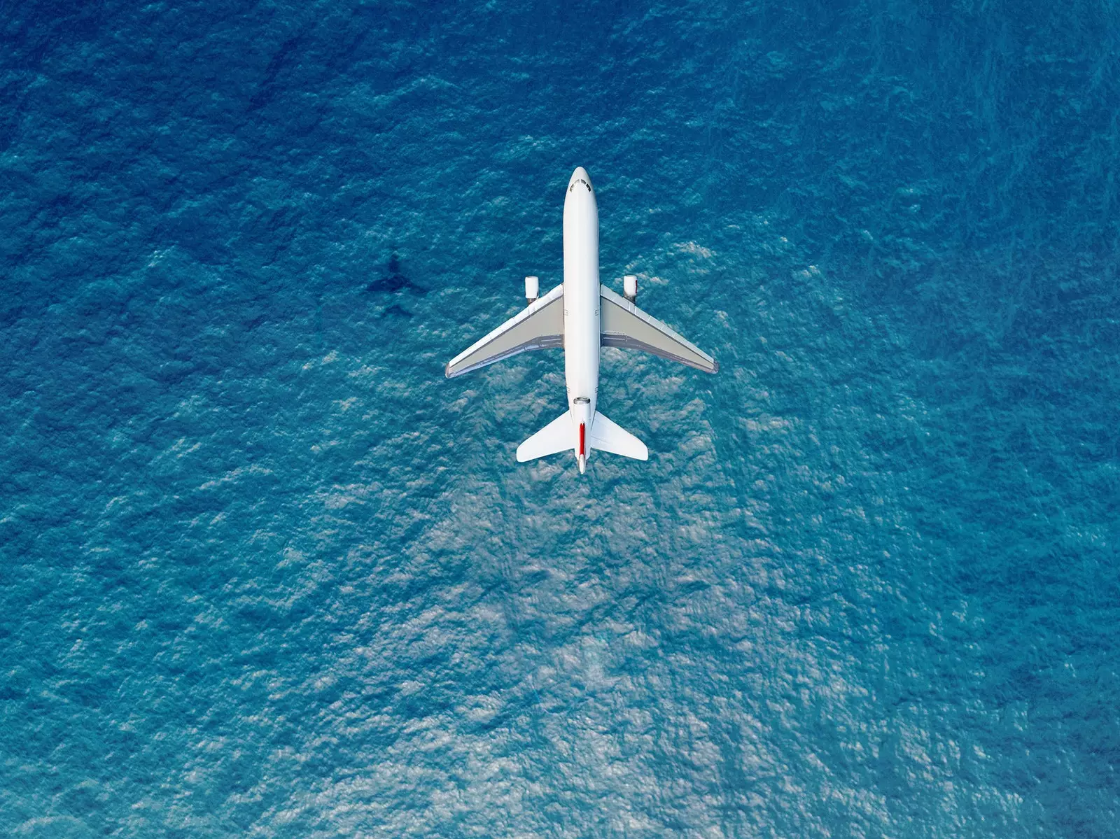 Airplane flying over the ocean