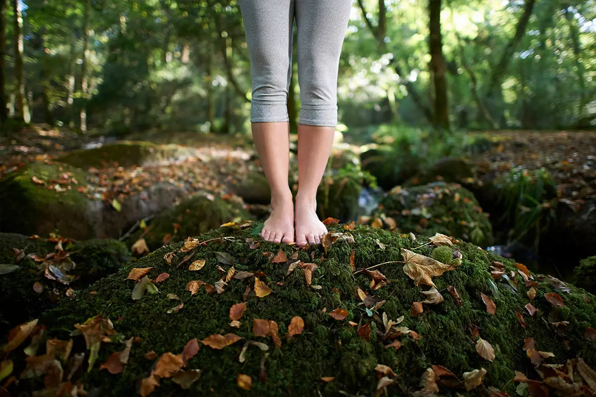 girl on stone with moss