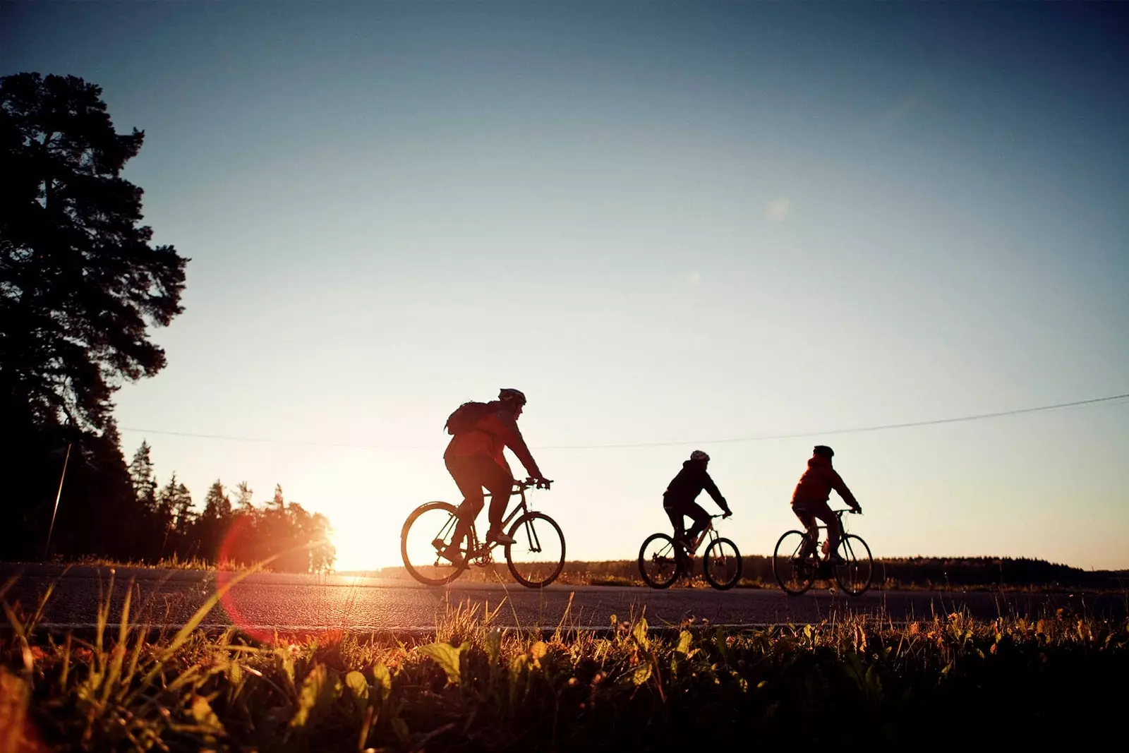 three people cycling through finland