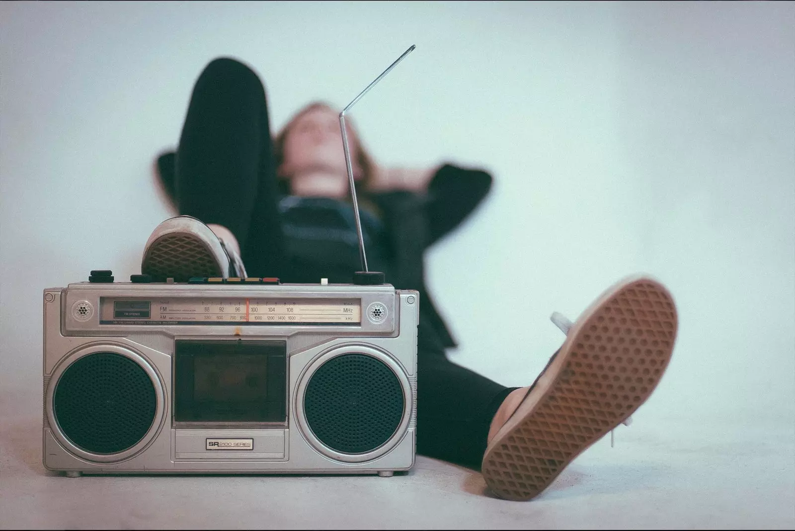 girl putting one foot on the stereo