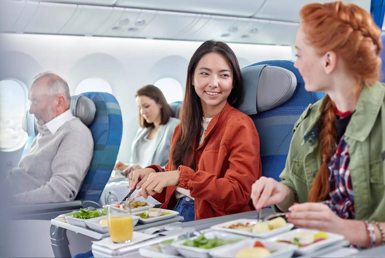 two girls eating on plane