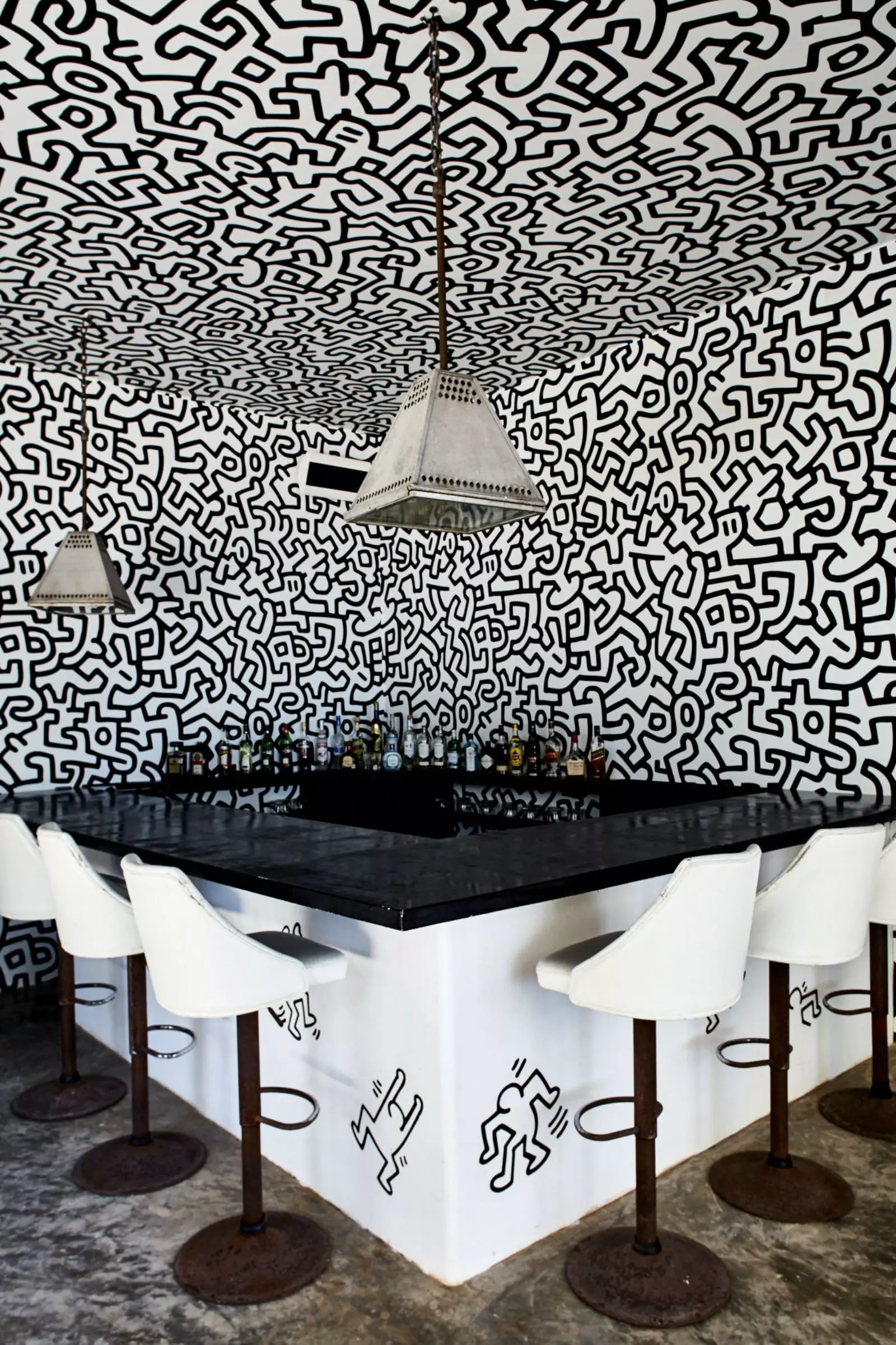 His bar with the art of Keith Haring.