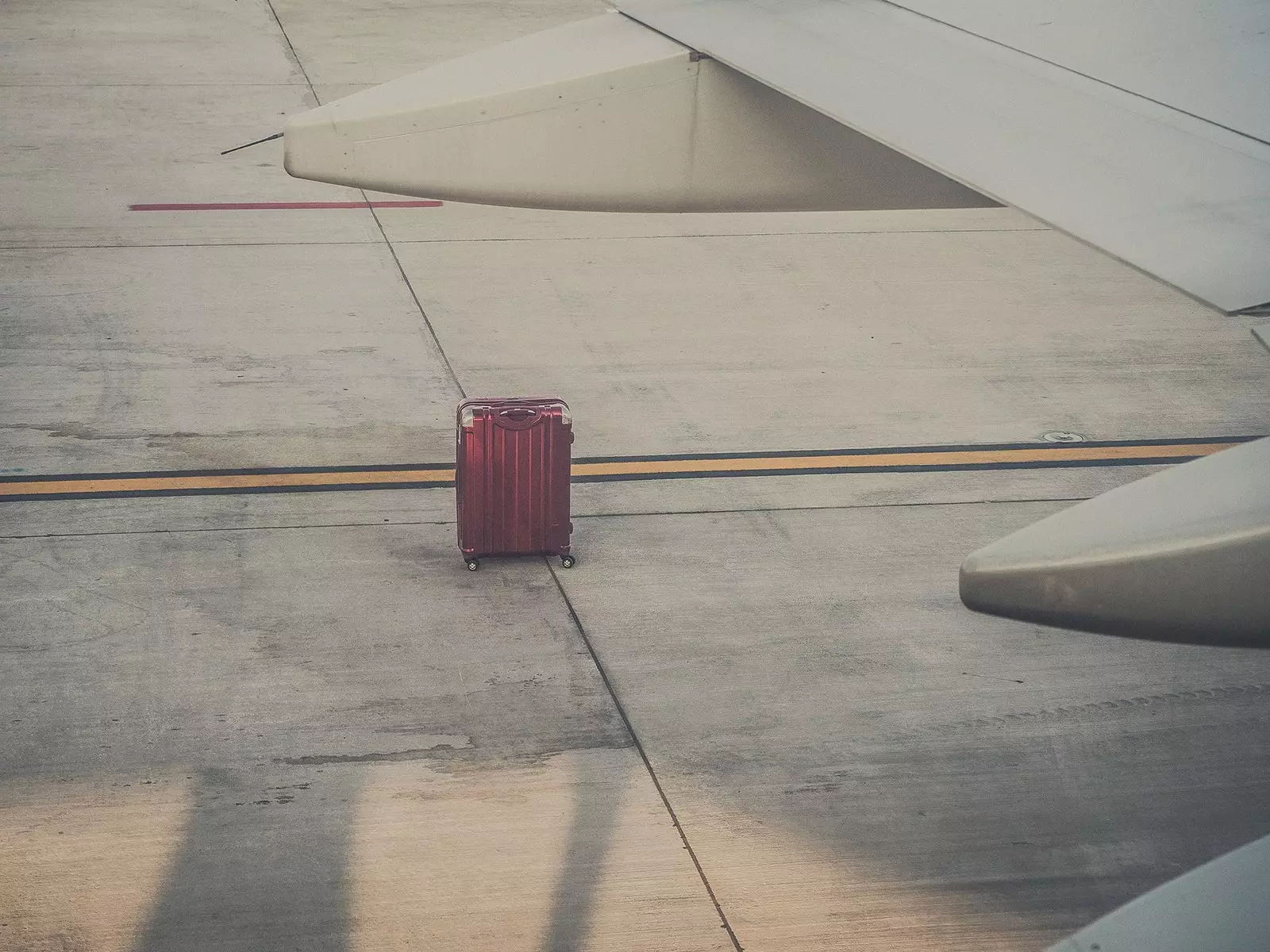 Lonely suitcase outside the plane