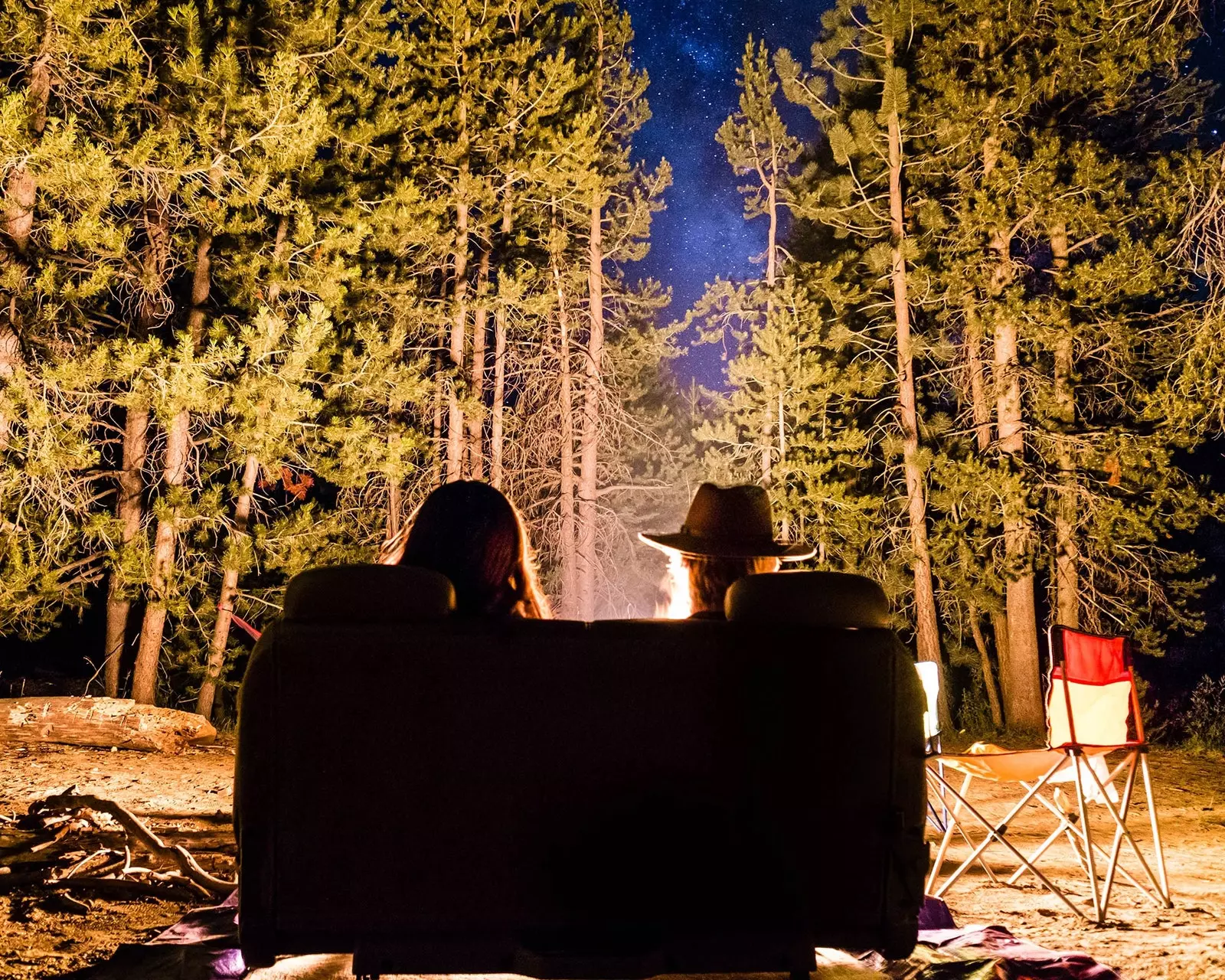 Girls enjoying a night at a camp in the woods