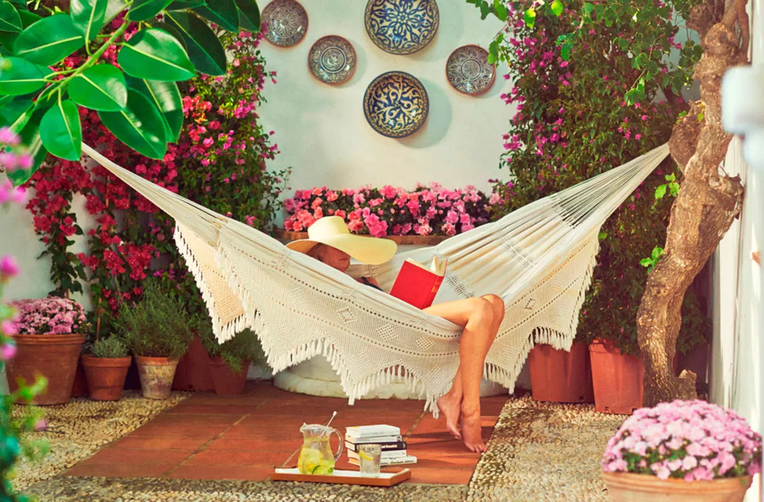 girl in a hammock reading in Marbella Club Hotel