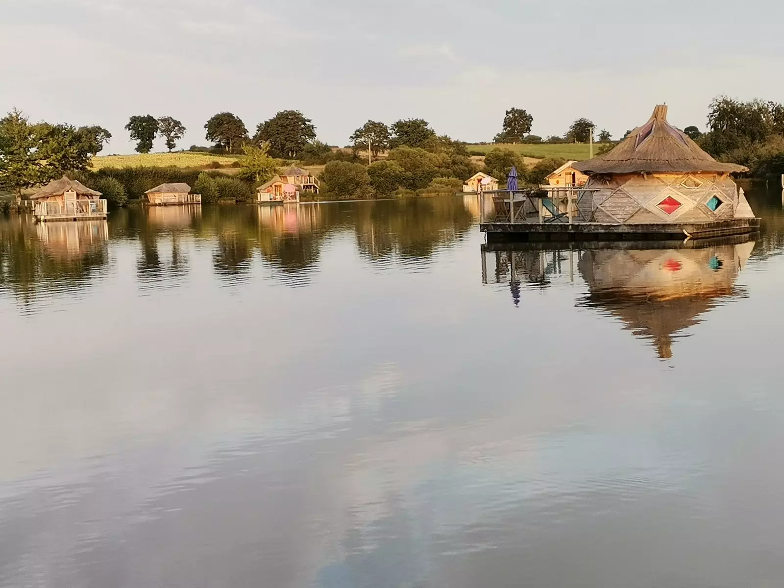 Cabins on the waters of a pond.