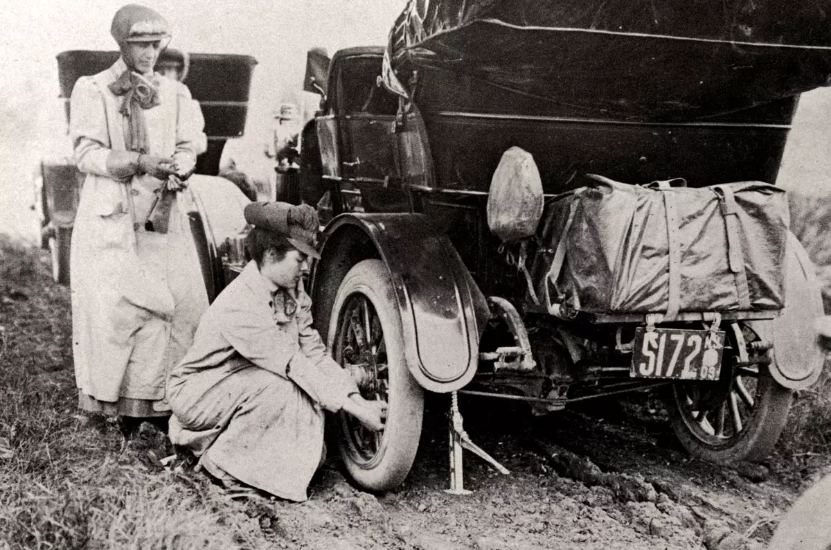 Alice Ramsey fixing car wheel