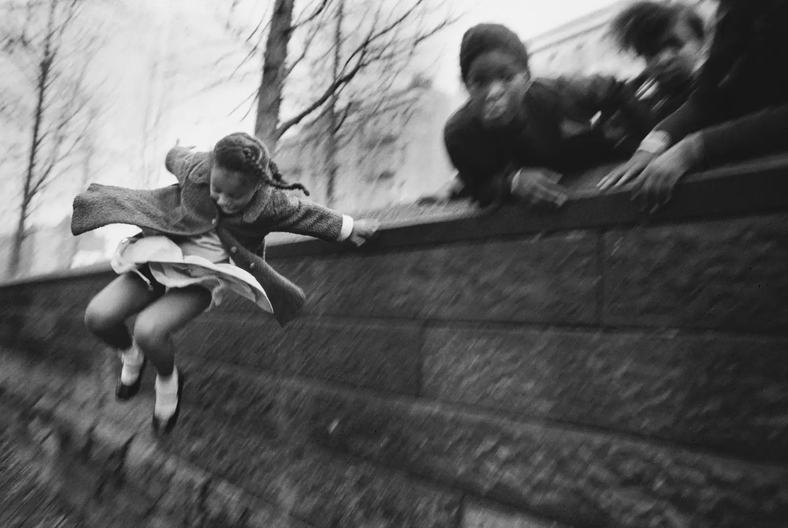 She girl climbing up a wall. Central Park New York United States 1967.