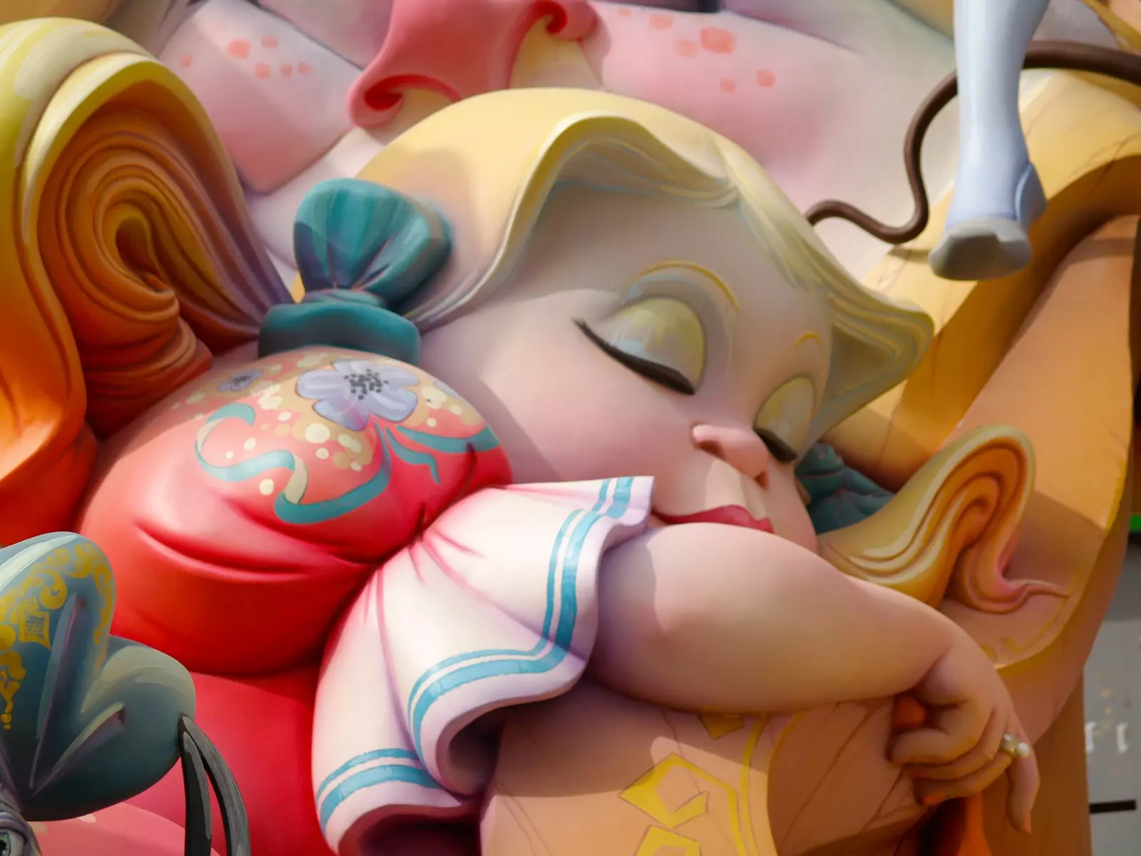 Close-up of a 'ninot' representing a blonde girl with her eyes closed.