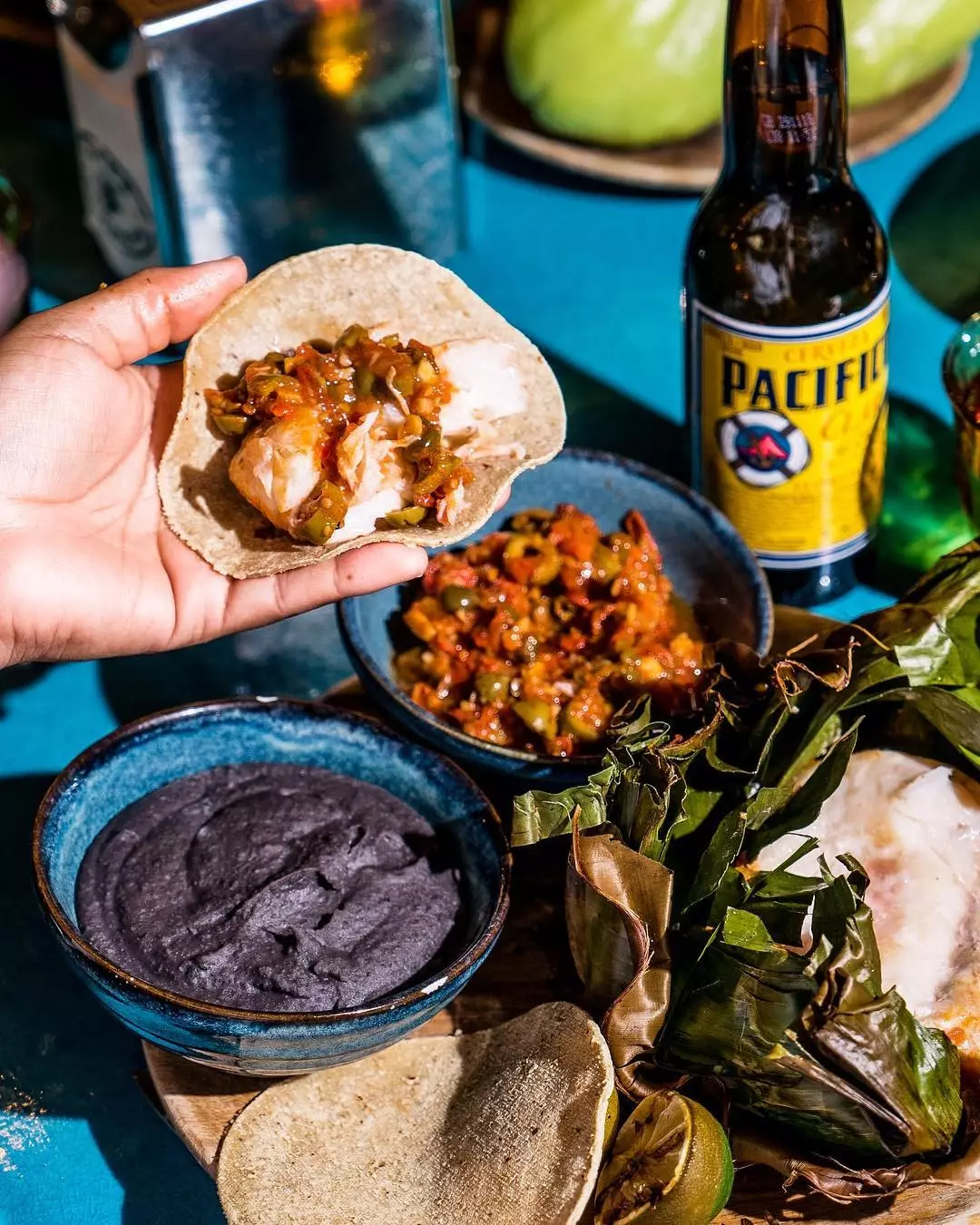 Veracruz-style hake baked in a banana leaf with tomatoes, capers, olives and herbs at Casa Pastor.