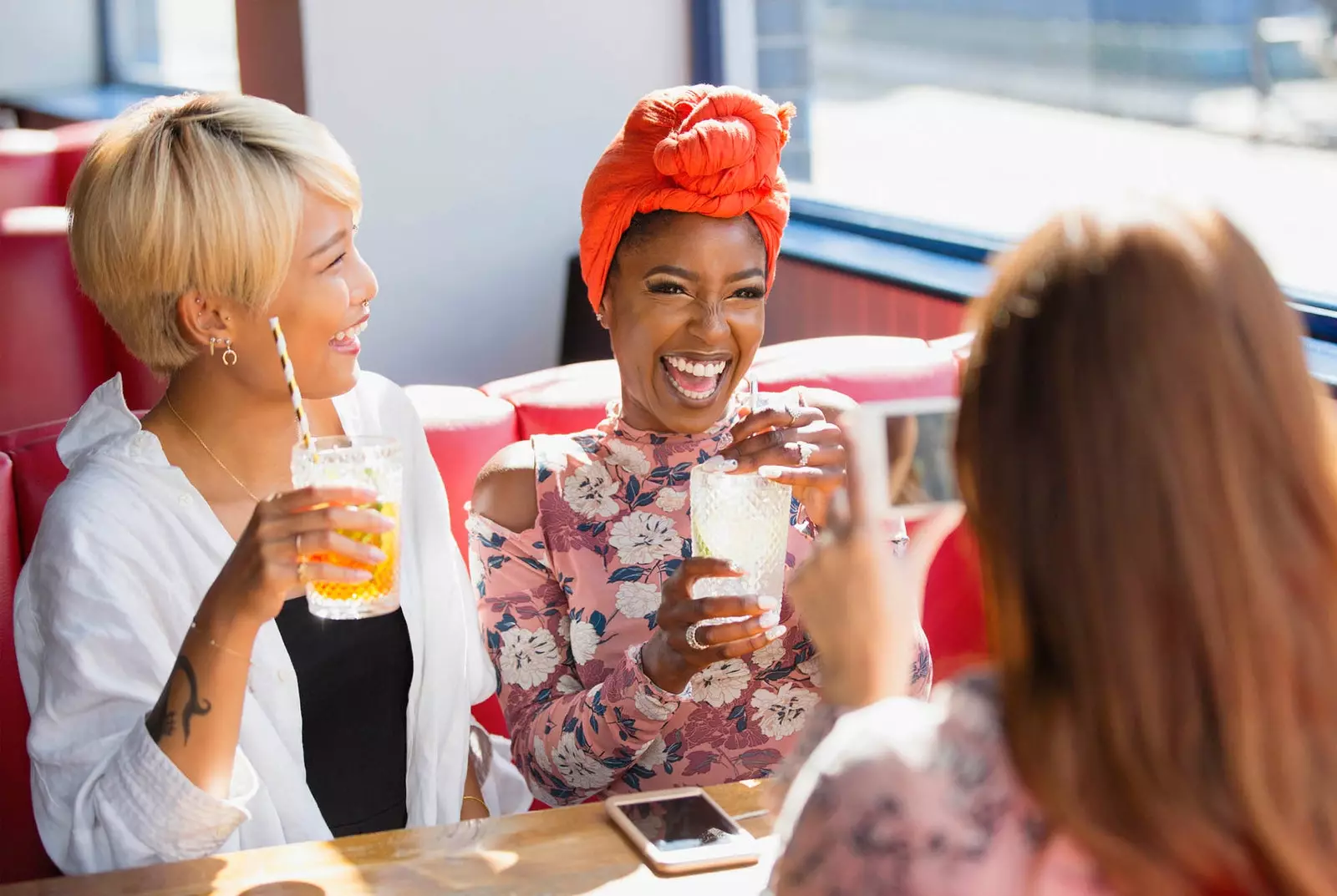 happy multiethnic female friends drinking