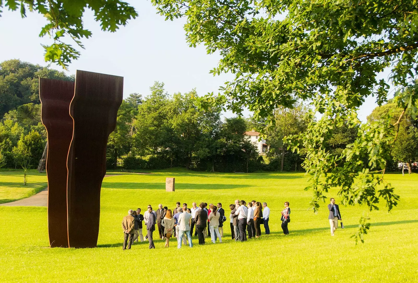 Group visiting Chillida Leku under the shadow of Searching for the light I